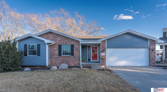 ranch-style house featuring a front lawn, concrete driveway, brick siding, and an attached garage