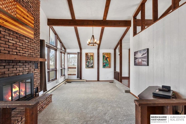 interior space with carpet floors, beam ceiling, a notable chandelier, a fireplace, and high vaulted ceiling