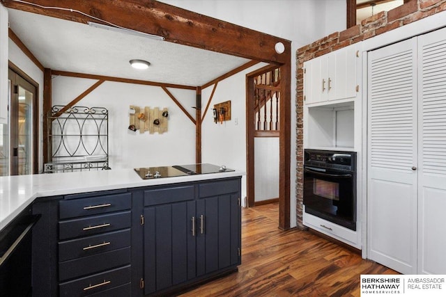 kitchen with dark wood-type flooring, white cabinets, light countertops, ornamental molding, and black appliances