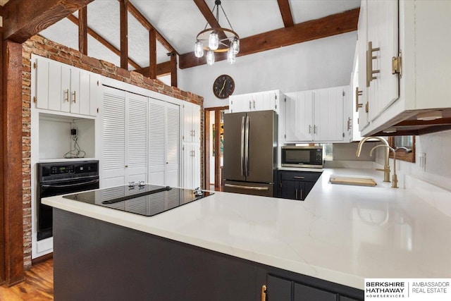 kitchen featuring vaulted ceiling with beams, light countertops, a sink, a peninsula, and black appliances