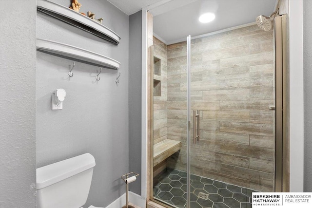 bathroom with a shower stall and toilet