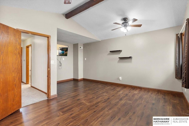 unfurnished room with lofted ceiling with beams, ceiling fan, a textured ceiling, wood finished floors, and baseboards