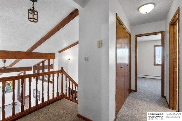 hall with carpet floors, a baseboard radiator, a textured ceiling, and an upstairs landing