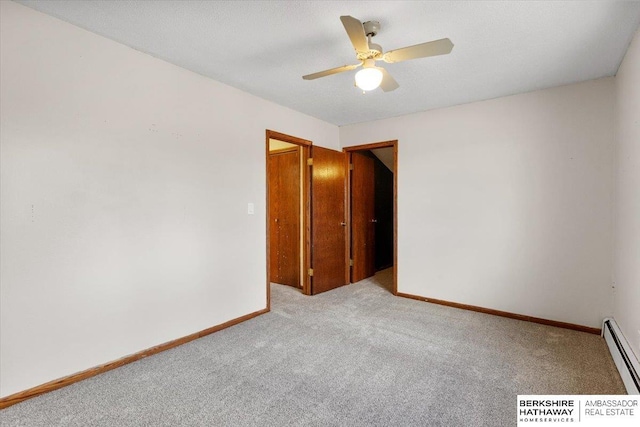 spare room featuring carpet floors, a baseboard heating unit, a ceiling fan, a textured ceiling, and baseboards