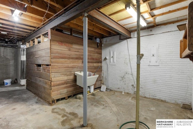 unfinished basement featuring brick wall