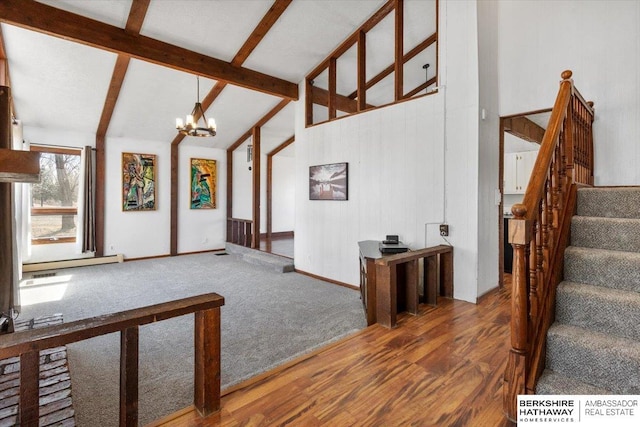 interior space with high vaulted ceiling, wood finished floors, stairs, beamed ceiling, and an inviting chandelier