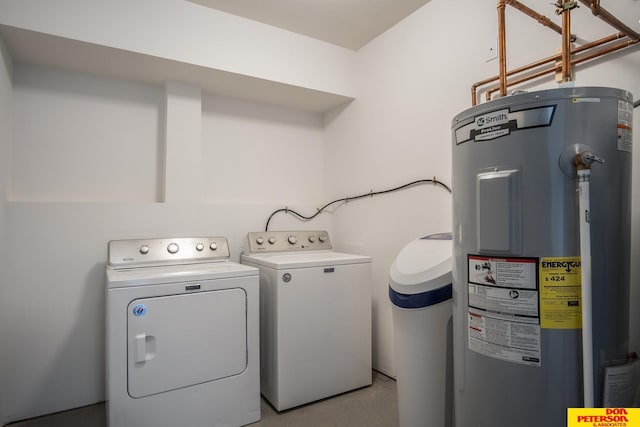 laundry room with laundry area, electric water heater, and independent washer and dryer