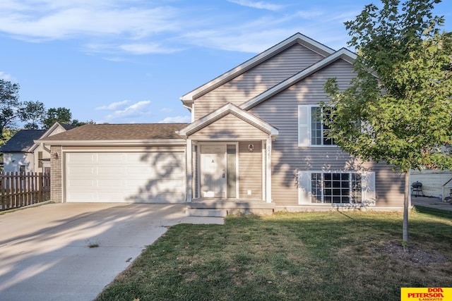 tri-level home featuring a garage, driveway, fence, a front lawn, and brick siding