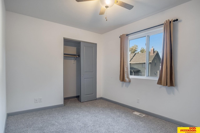 unfurnished bedroom with carpet floors, a closet, visible vents, and baseboards