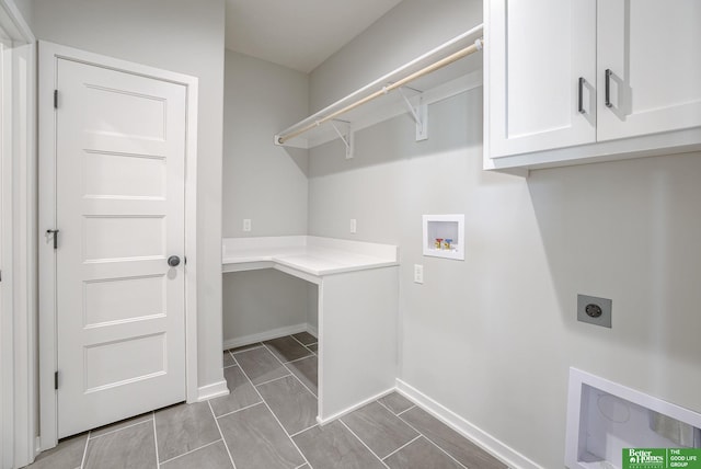 laundry area featuring washer hookup, cabinet space, hookup for an electric dryer, and baseboards