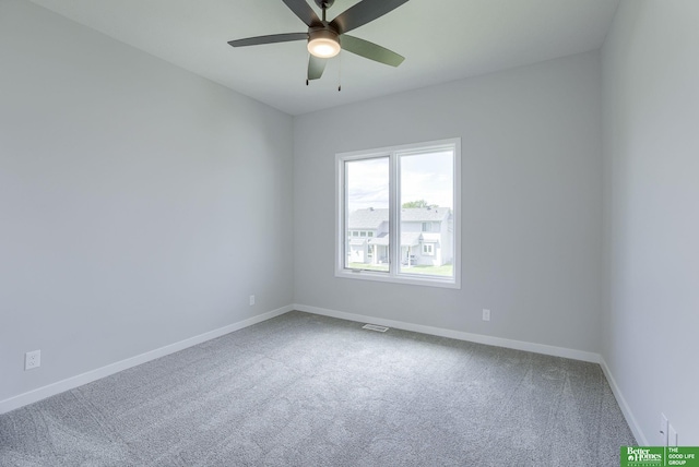 spare room featuring carpet floors, baseboards, visible vents, and a ceiling fan