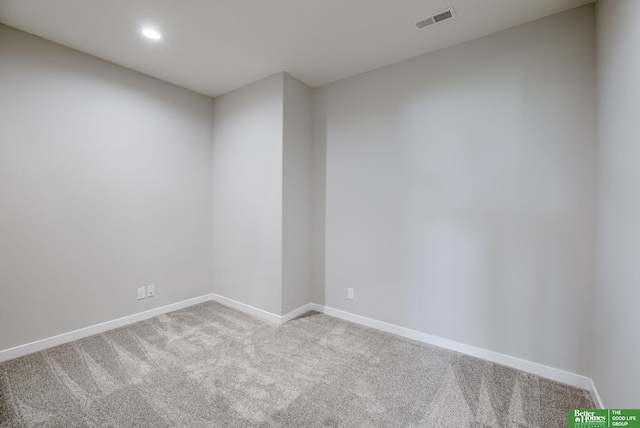 carpeted empty room featuring baseboards, visible vents, and recessed lighting