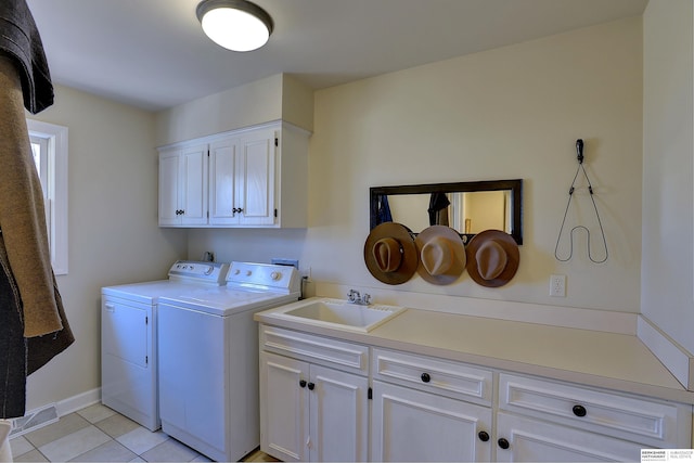 clothes washing area featuring cabinet space, light tile patterned floors, a sink, and independent washer and dryer