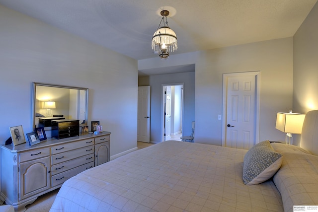 bedroom with baseboards and an inviting chandelier