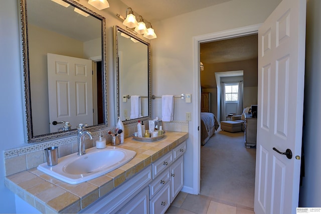 ensuite bathroom featuring ensuite bathroom, tile patterned flooring, and vanity