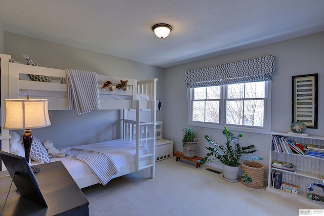 carpeted bedroom featuring a textured ceiling