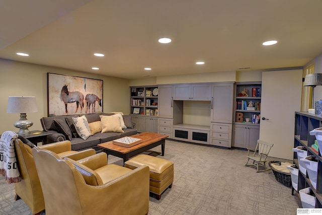 living area featuring light colored carpet and recessed lighting