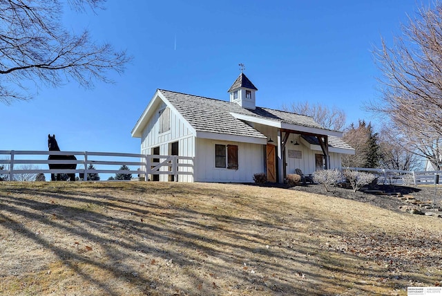 view of front of house featuring fence and board and batten siding