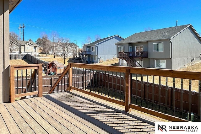 wooden deck featuring fence and a residential view