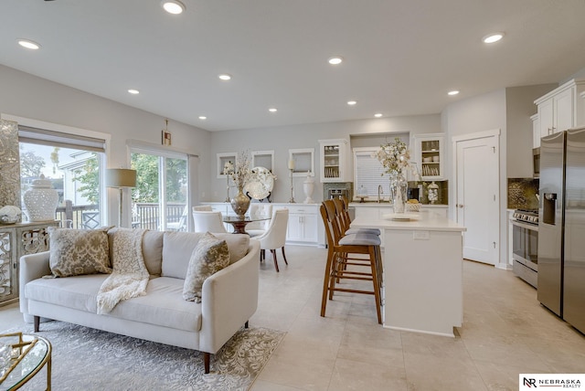 living room with light tile patterned floors and recessed lighting