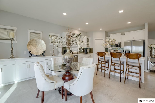 dining space featuring recessed lighting