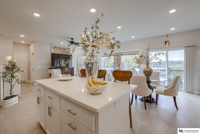 kitchen with recessed lighting, a center island, and white cabinetry