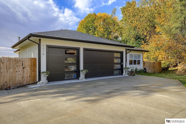 exterior space featuring fence and concrete driveway