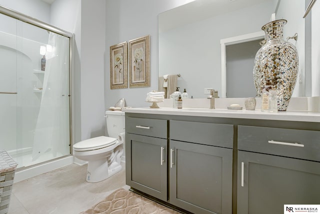 bathroom with vanity, a shower stall, and toilet