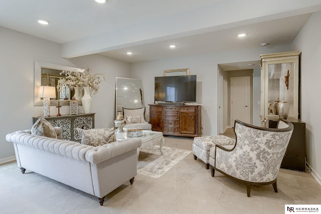 living room featuring baseboards, beamed ceiling, and recessed lighting