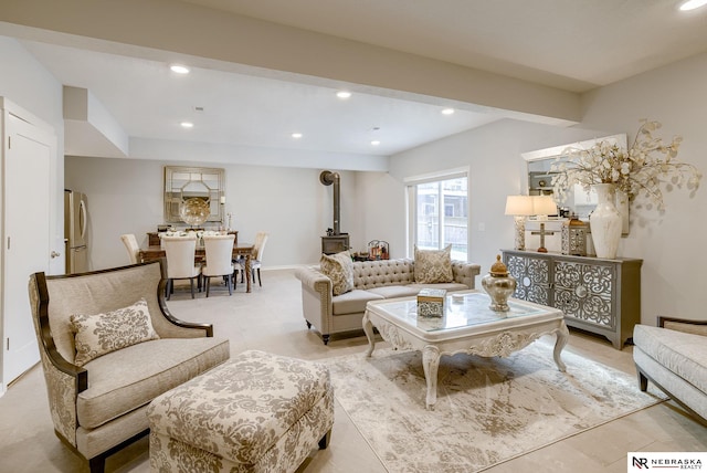 living room with a wood stove, baseboards, and recessed lighting