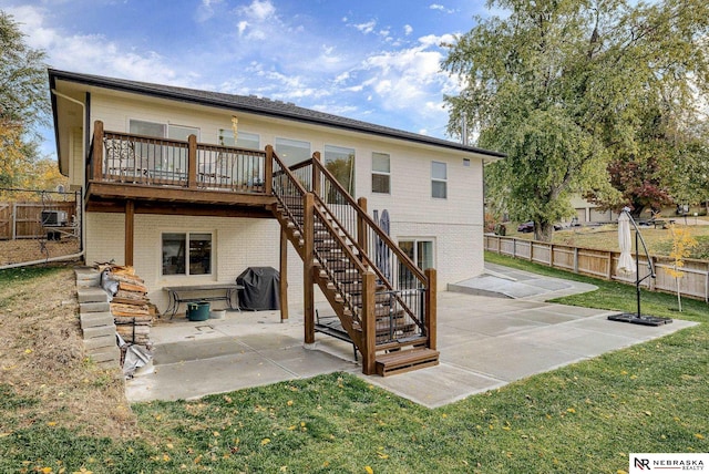 back of house featuring a yard, brick siding, stairs, and a patio