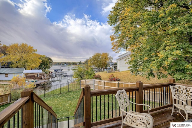 wooden deck with a fenced backyard and a lawn