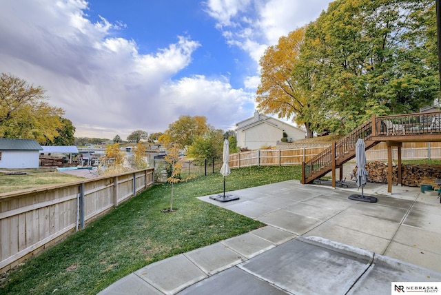 view of yard featuring a fenced backyard, a patio, and stairs