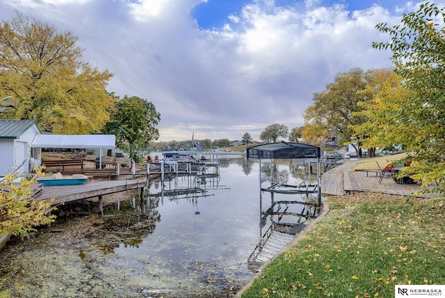 dock area with a water view and boat lift