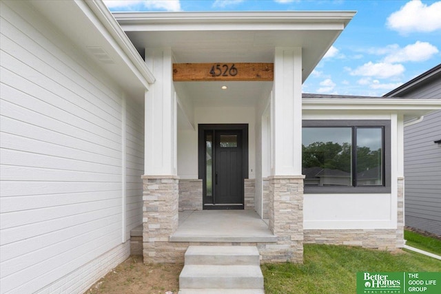 entrance to property with stone siding