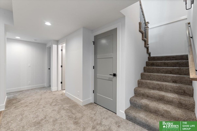 staircase featuring baseboards, carpet flooring, and recessed lighting