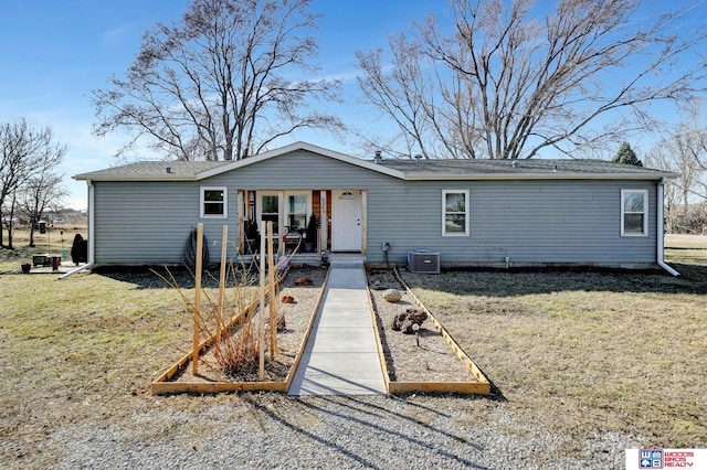 view of front of property with a front lawn, central air condition unit, and covered porch