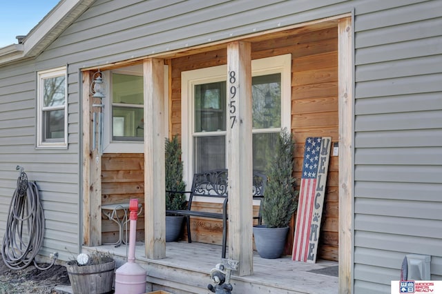 view of exterior entry with covered porch