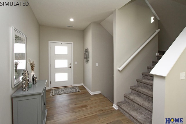 entryway featuring light wood-type flooring, stairway, baseboards, and recessed lighting