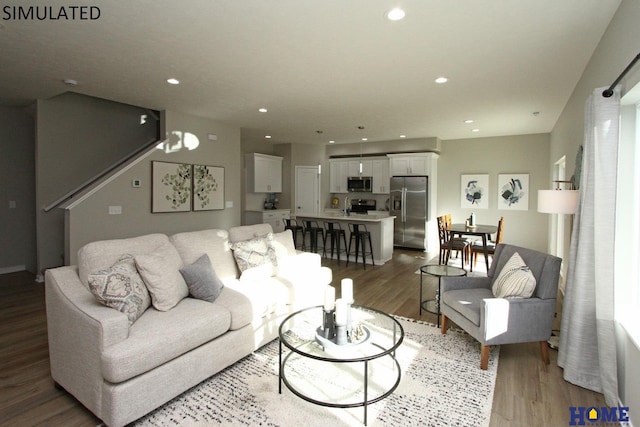 living room with wood finished floors and recessed lighting