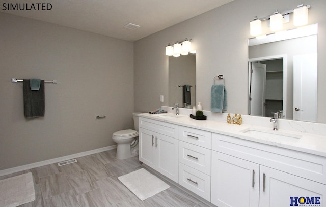 full bath featuring visible vents, a sink, toilet, and double vanity