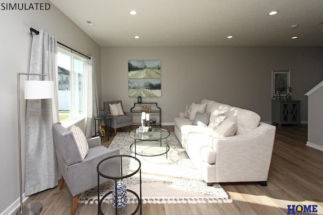 living room featuring recessed lighting, baseboards, and wood finished floors