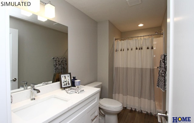 full bathroom featuring visible vents, toilet, wood finished floors, curtained shower, and vanity