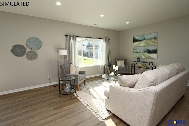 living room featuring baseboards, wood finished floors, and recessed lighting