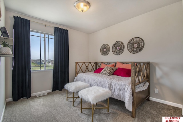 carpeted bedroom with visible vents and baseboards