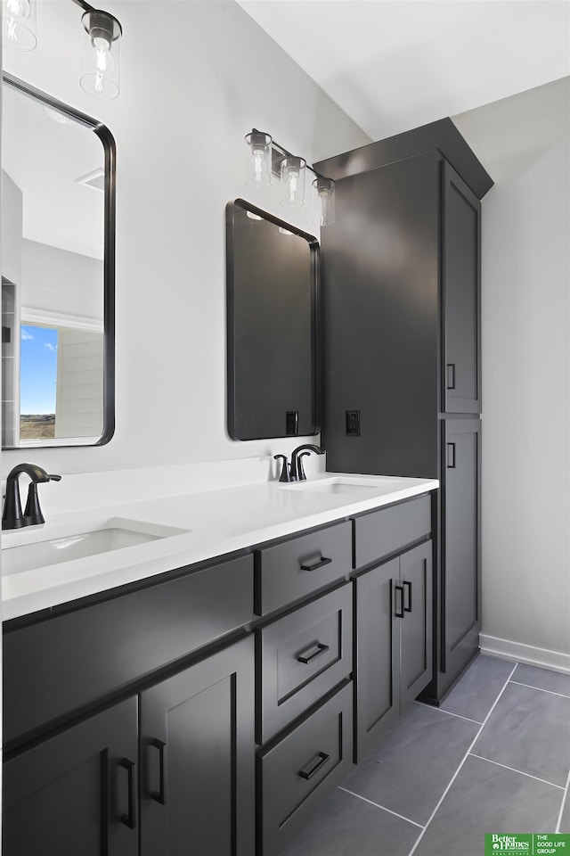 full bath featuring double vanity, a sink, and tile patterned floors