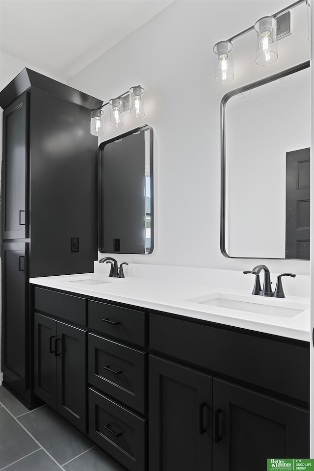 full bath with tile patterned flooring, a sink, and double vanity