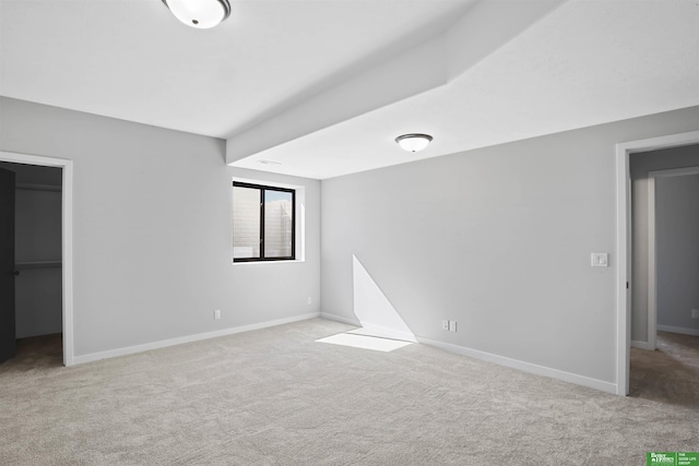 carpeted spare room with baseboards