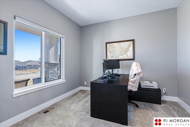 carpeted home office with visible vents and baseboards