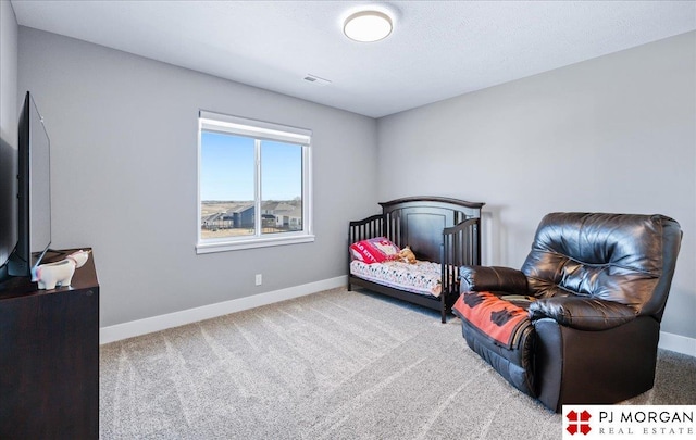 bedroom featuring carpet floors, visible vents, baseboards, and a textured ceiling